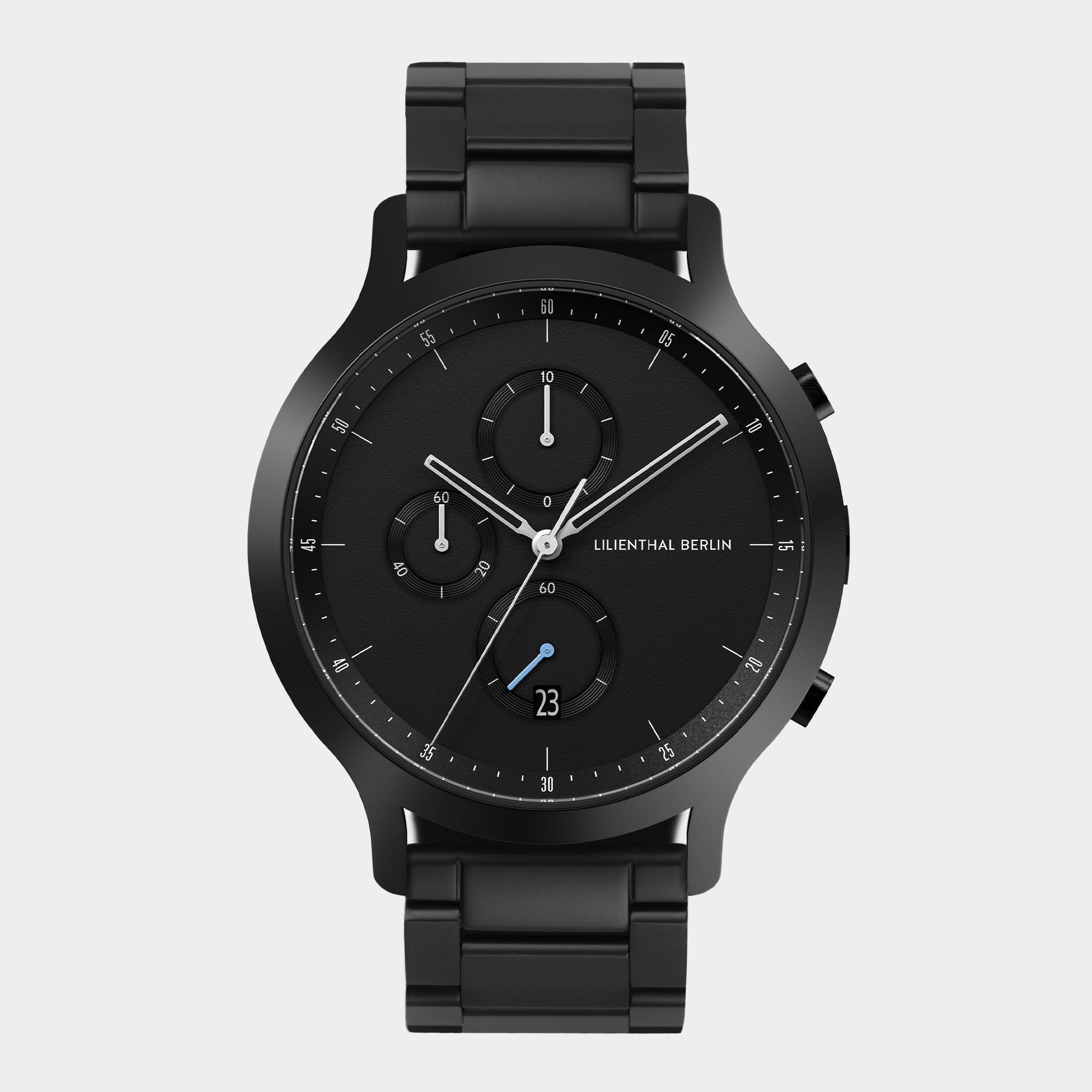 Black chronograph wristwatch with metal band, minimalist dial and three subdials on white background