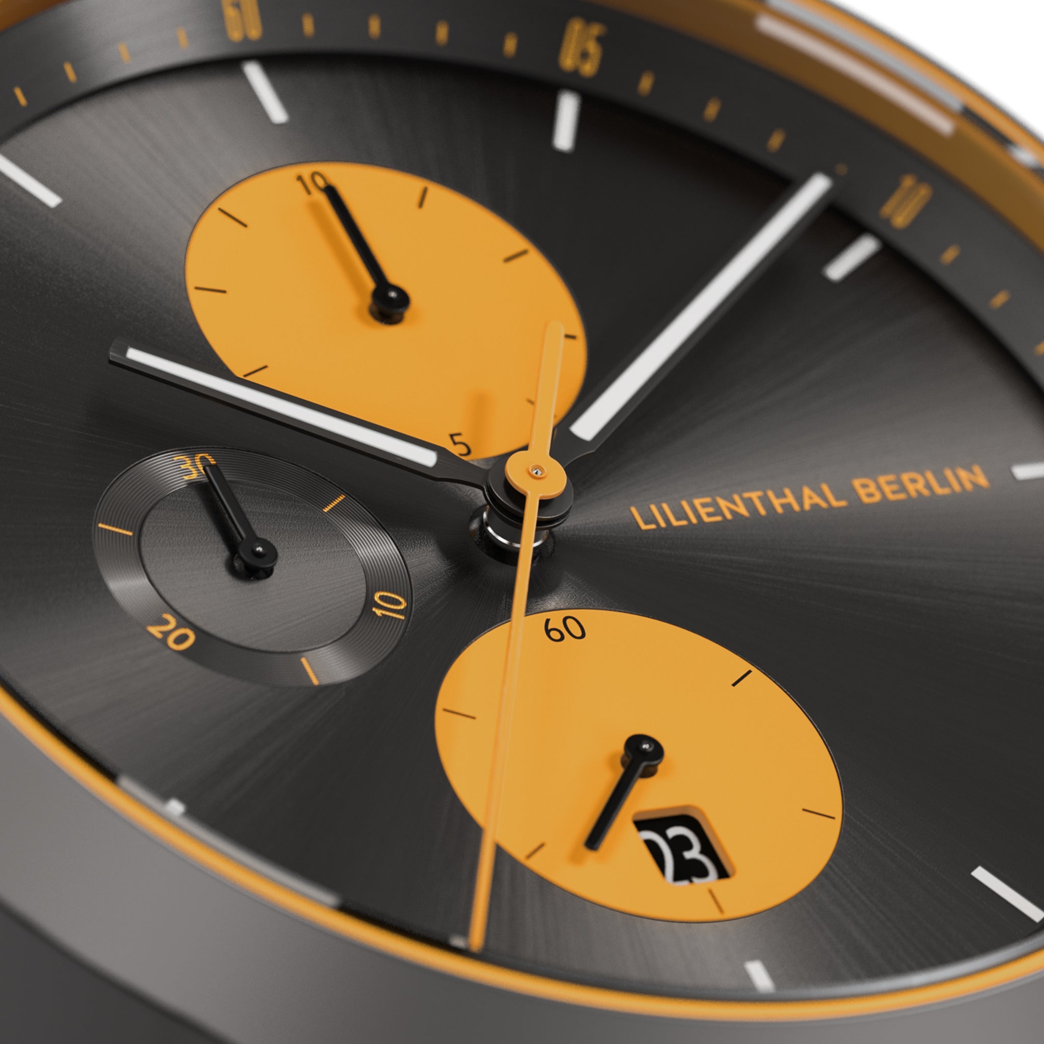 Close-up of modern chronograph watch with black and orange dial, subdials, and date display.