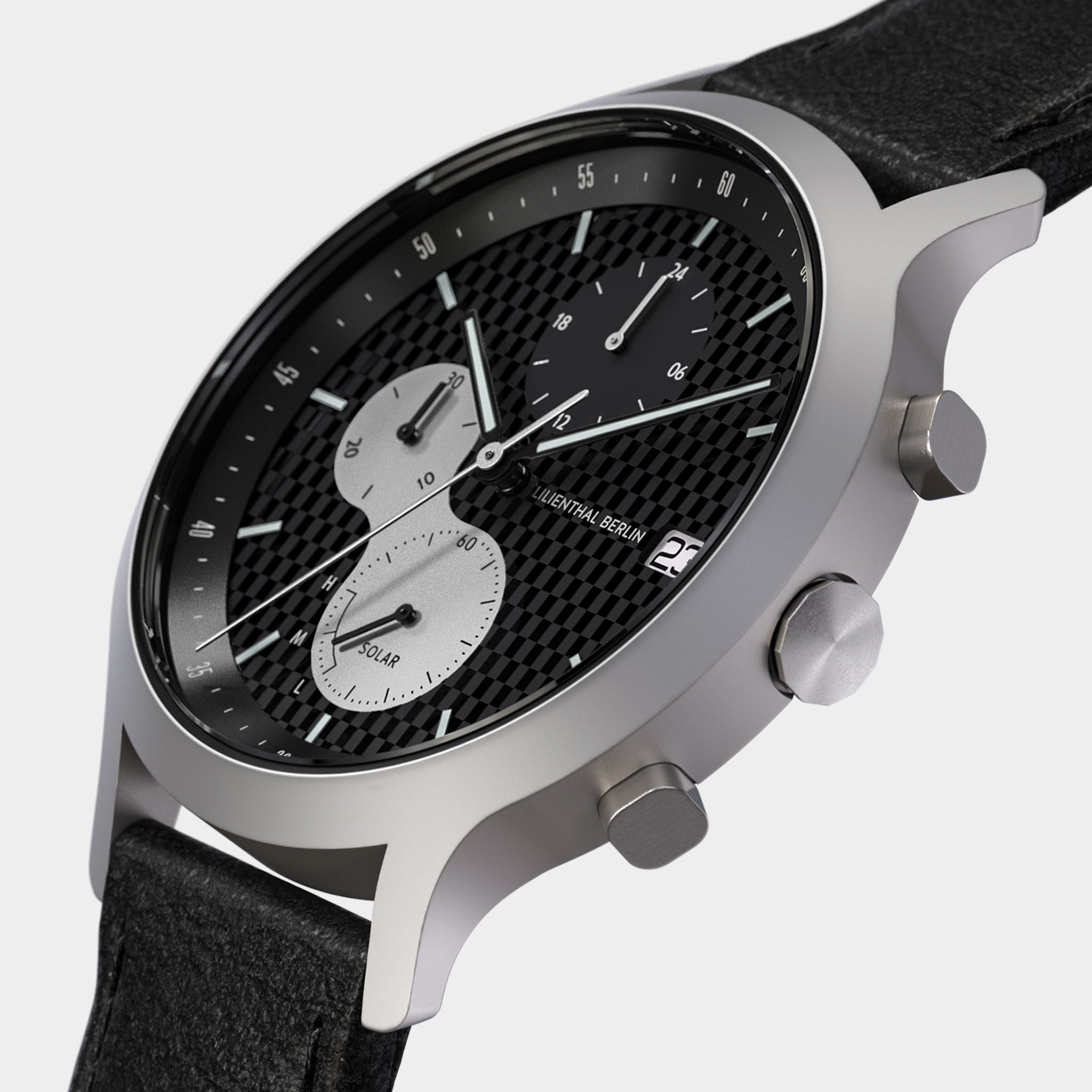 Modern chronograph wristwatch with black textured dial, three subdials, and leather strap
