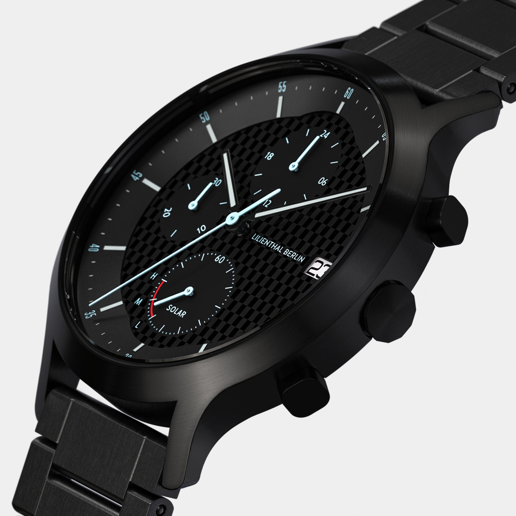 Close-up of a black solar-powered chronograph watch with steel bracelet and textured dial.