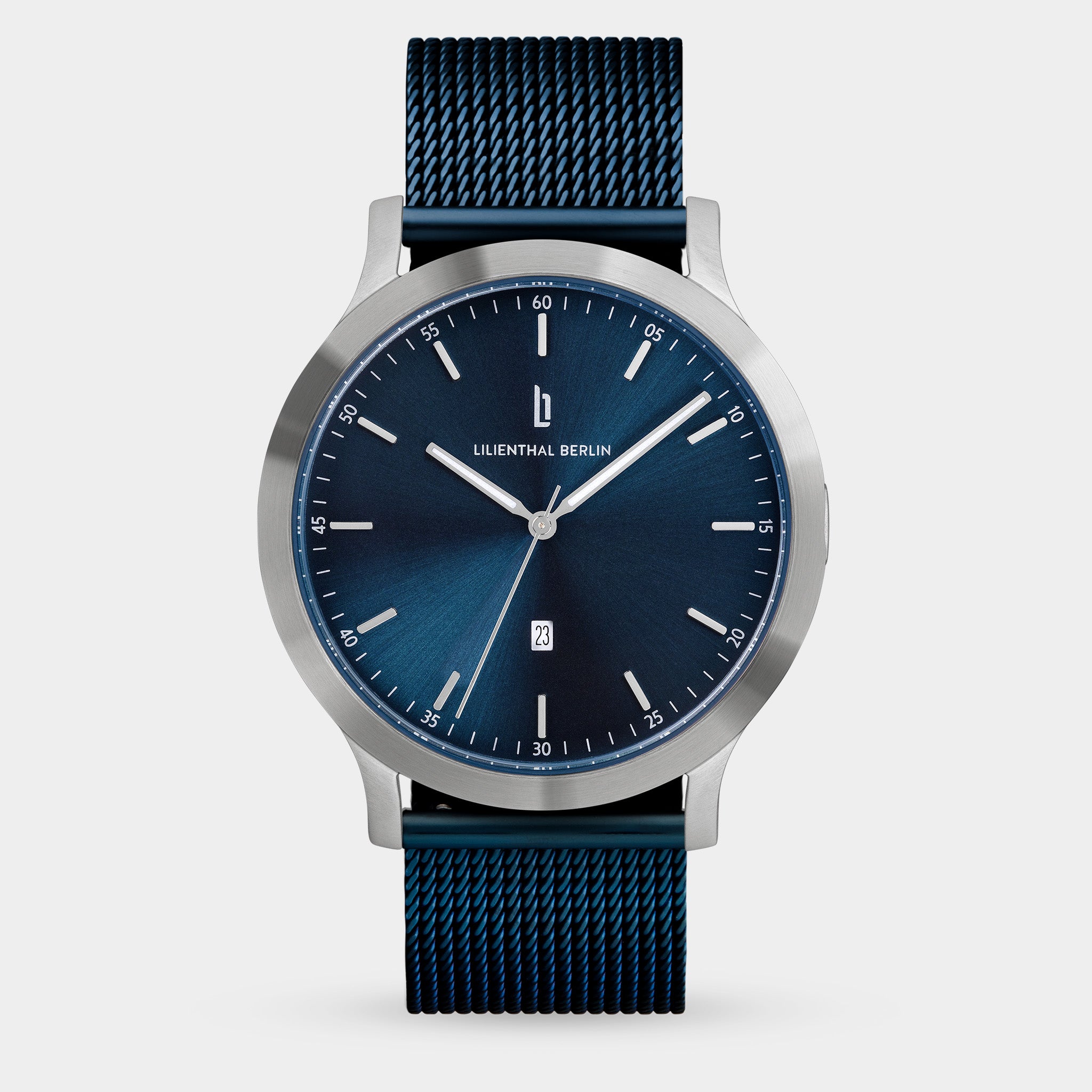Minimalist blue dial wristwatch with mesh strap, silver case, and date display