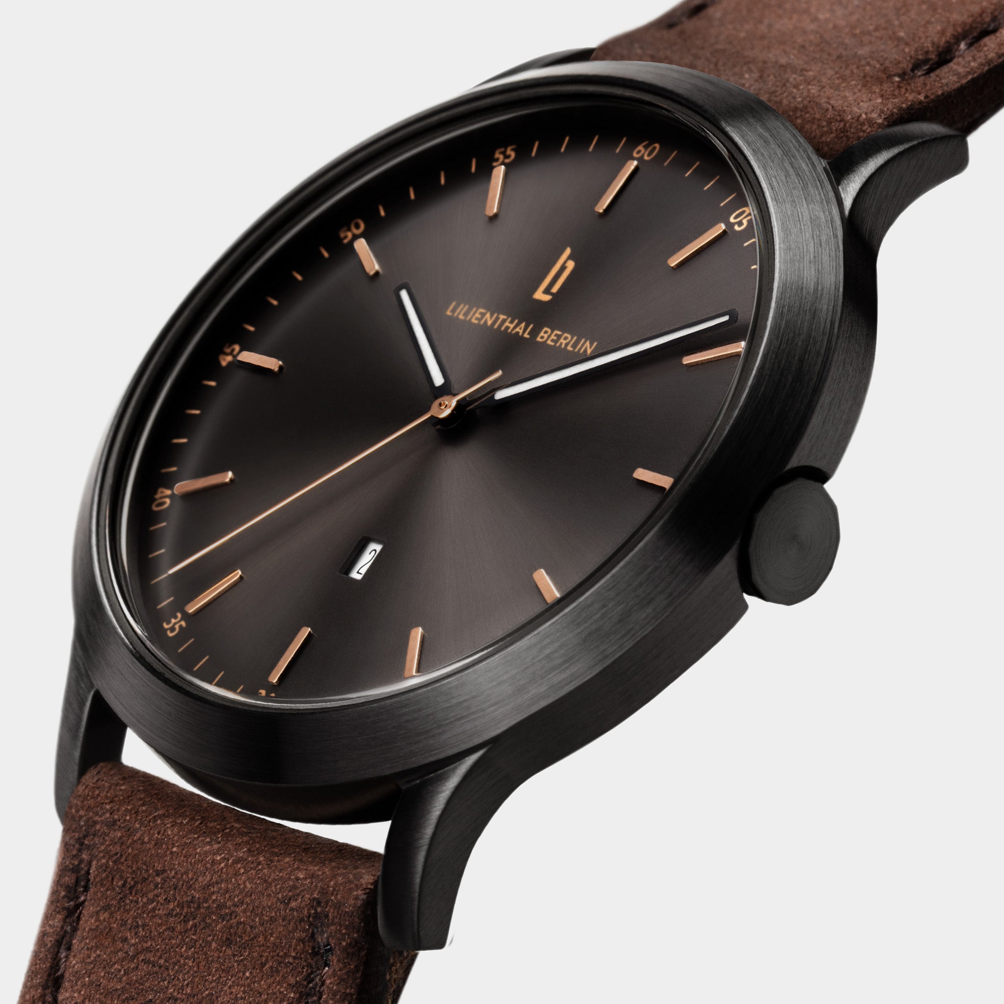 Elegant minimalist black watch with brown leather strap and gold accents on dial