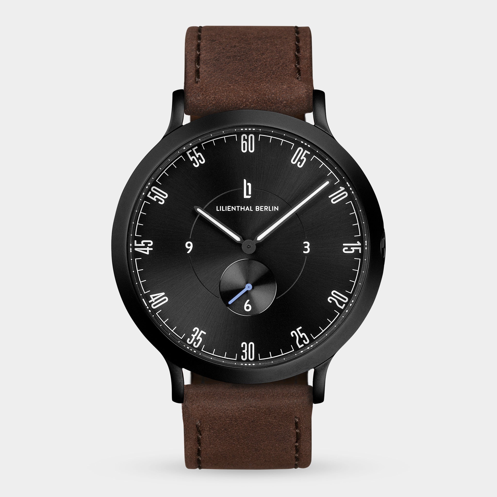 Minimalist black dial wristwatch with brown leather strap and subdial, modern design