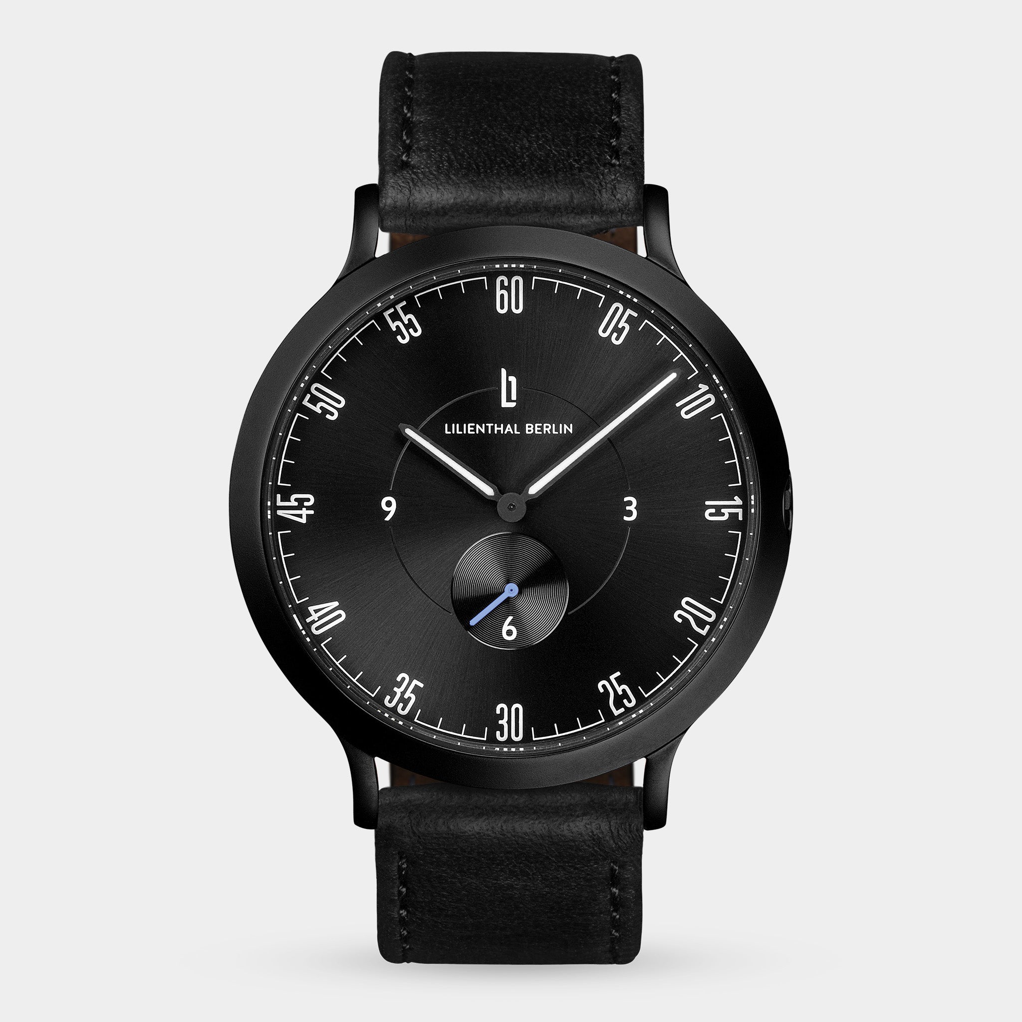 Black minimalist wristwatch with a black leather strap and sleek dial design