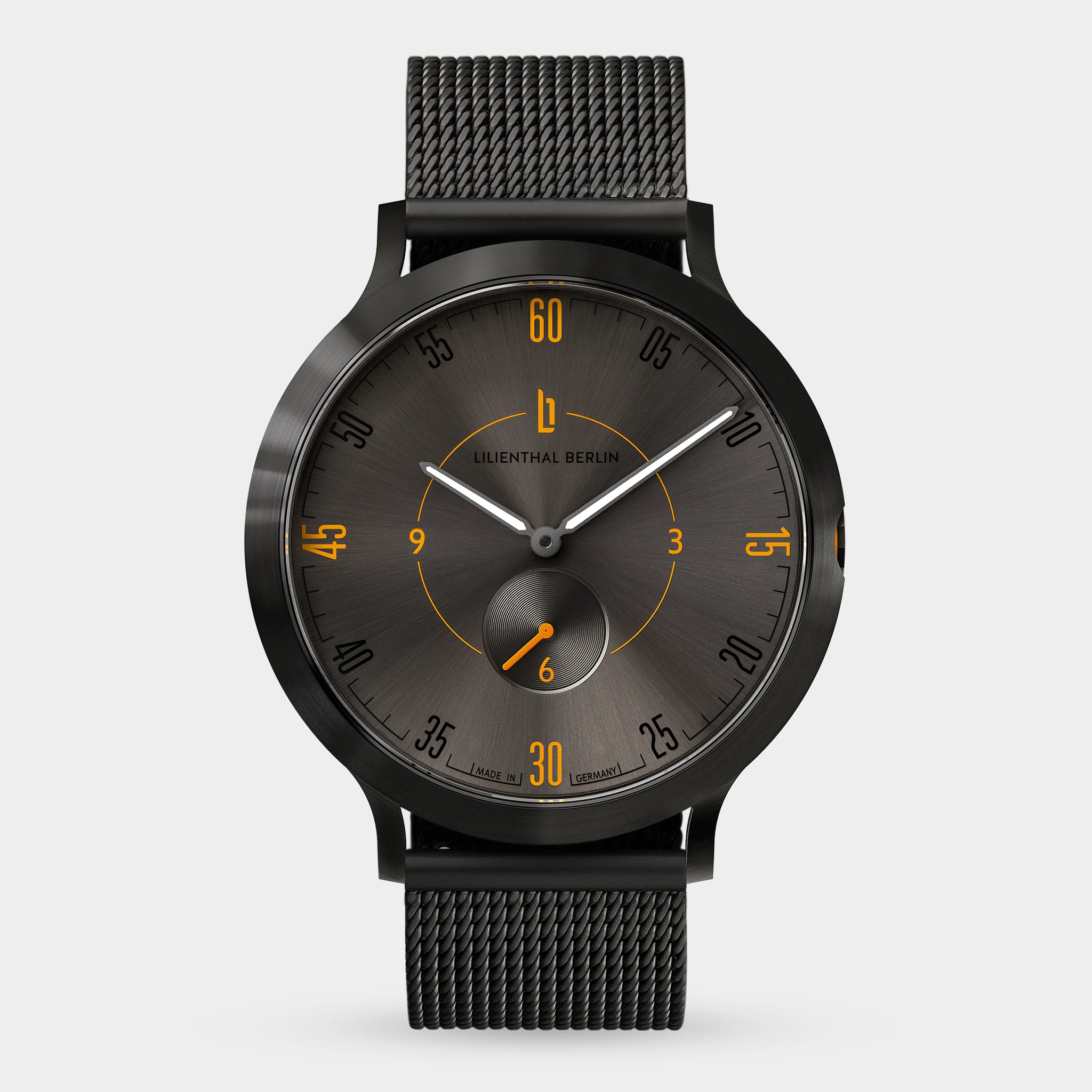 Black mesh strap watch with dark dial and orange accents, minimalist modern design