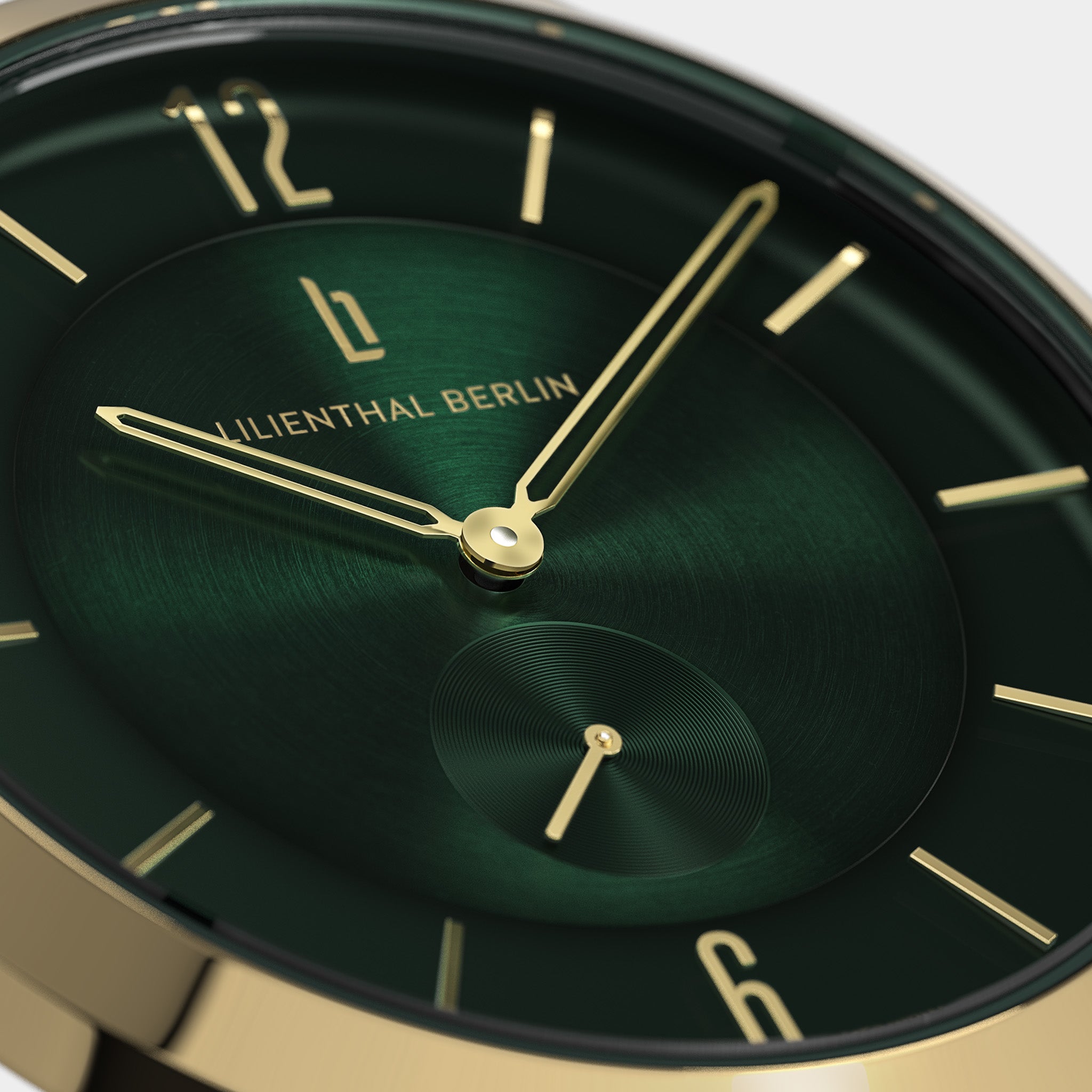 Close-up of green watch dial with gold hands and minimalist markers