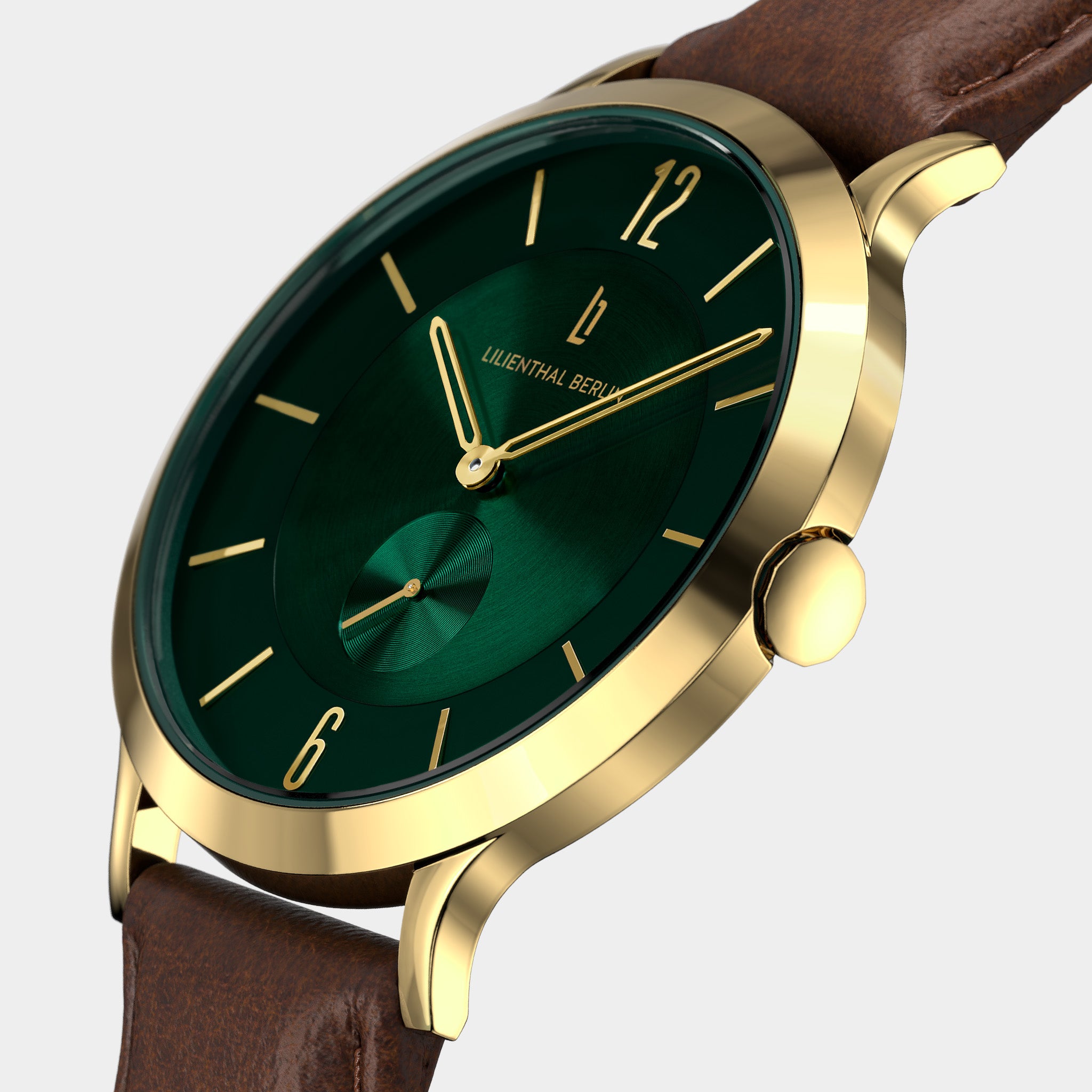 Elegant gold wristwatch with green dial and brown leather strap on light background