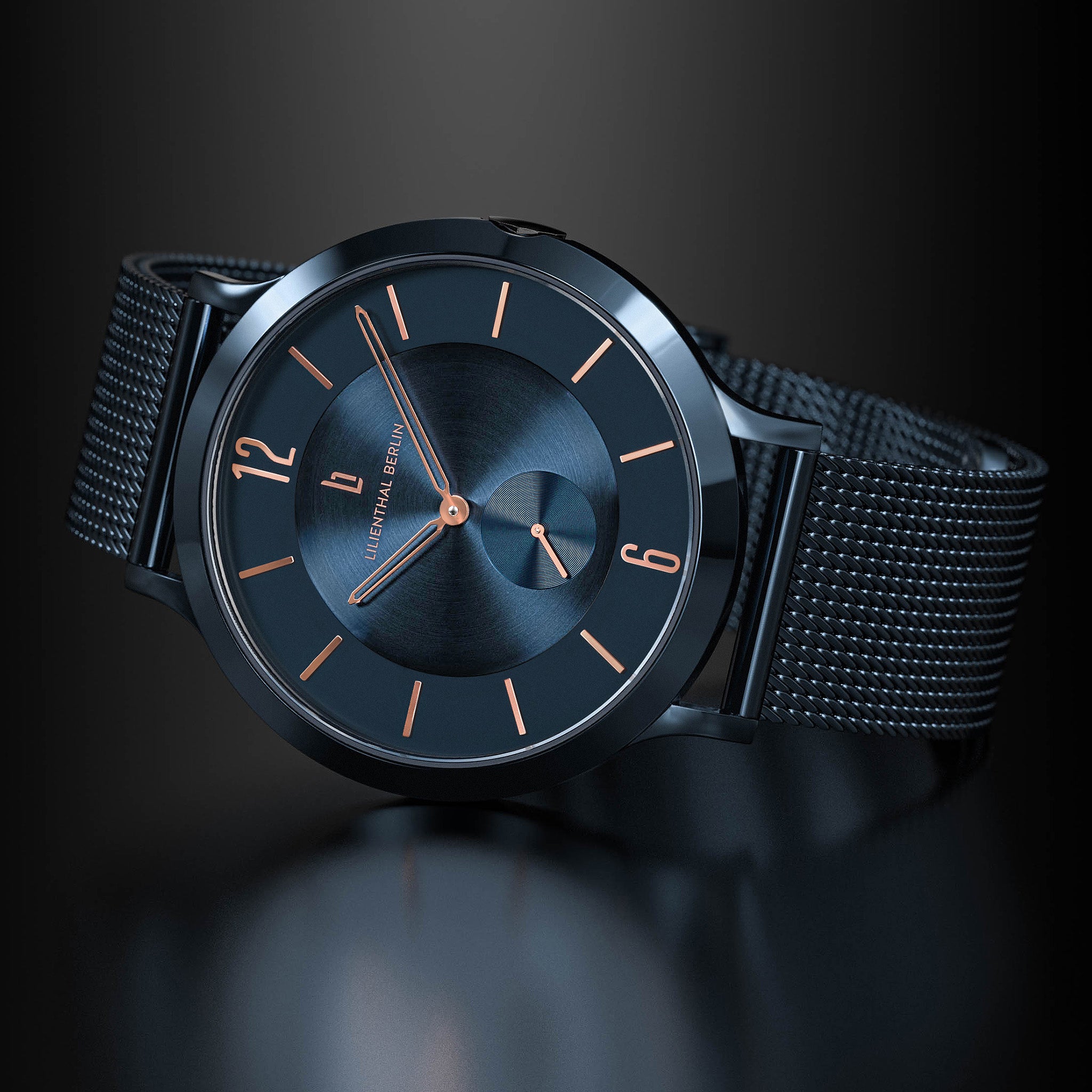 Modern black mesh strap watch with minimalist blue dial and rose gold hour markers