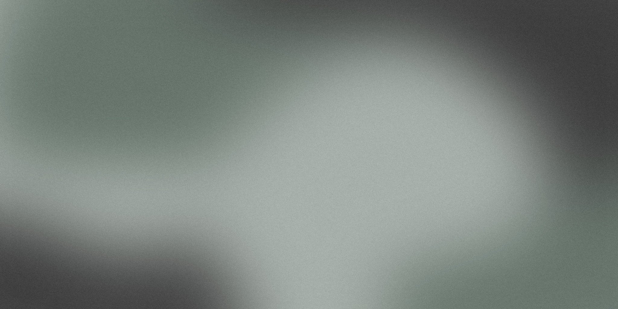 Minimalist green and gray gradient background with soft, blurred abstract shapes
