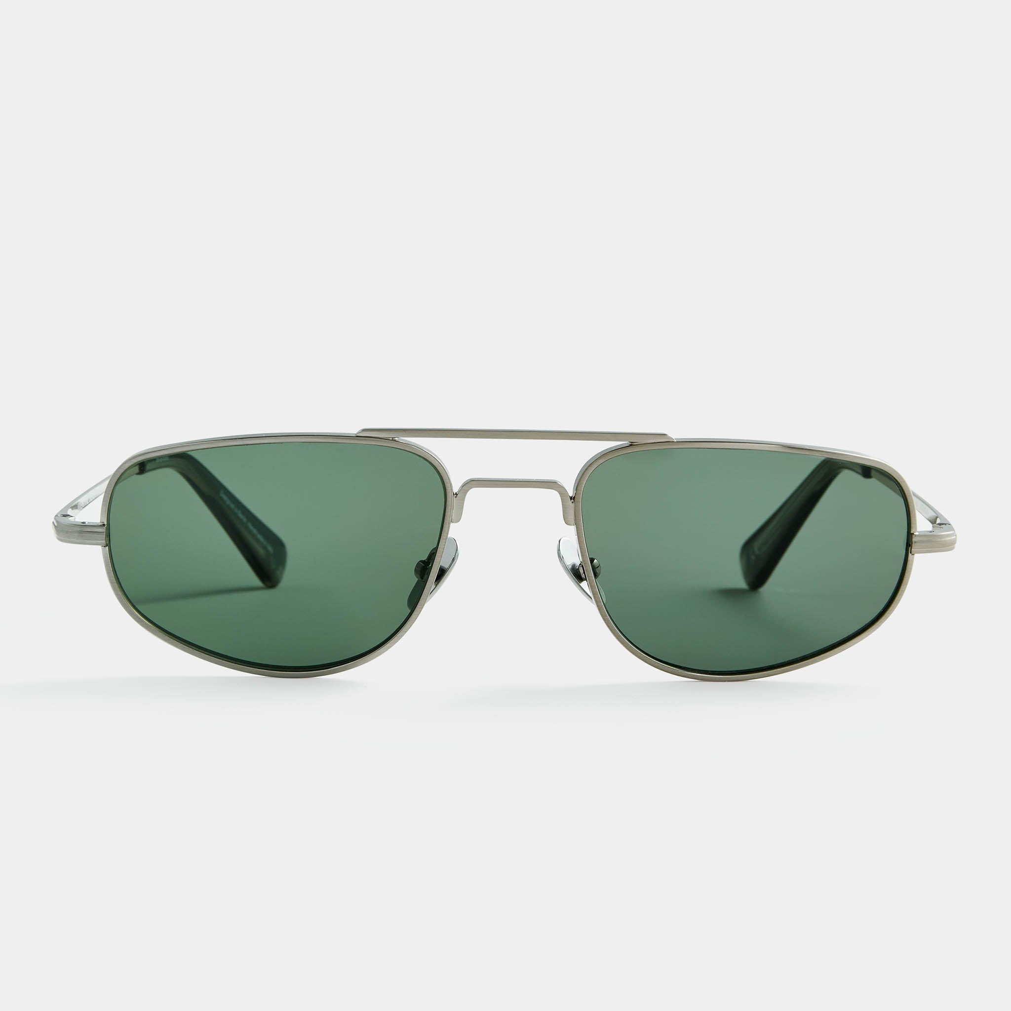 Silver aviator sunglasses with green lenses on white background