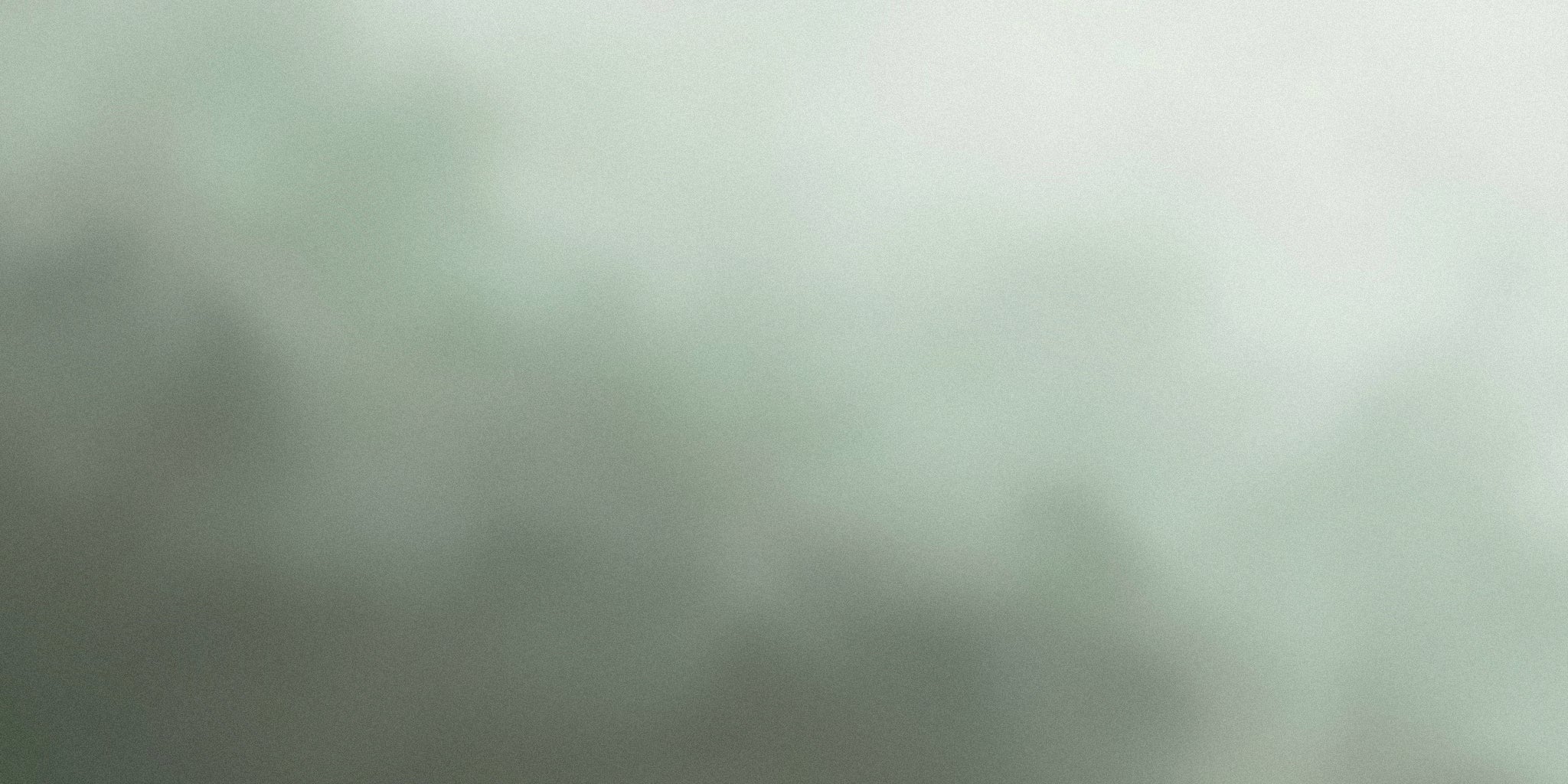 Soft green grey gradient background with subtle abstract texture