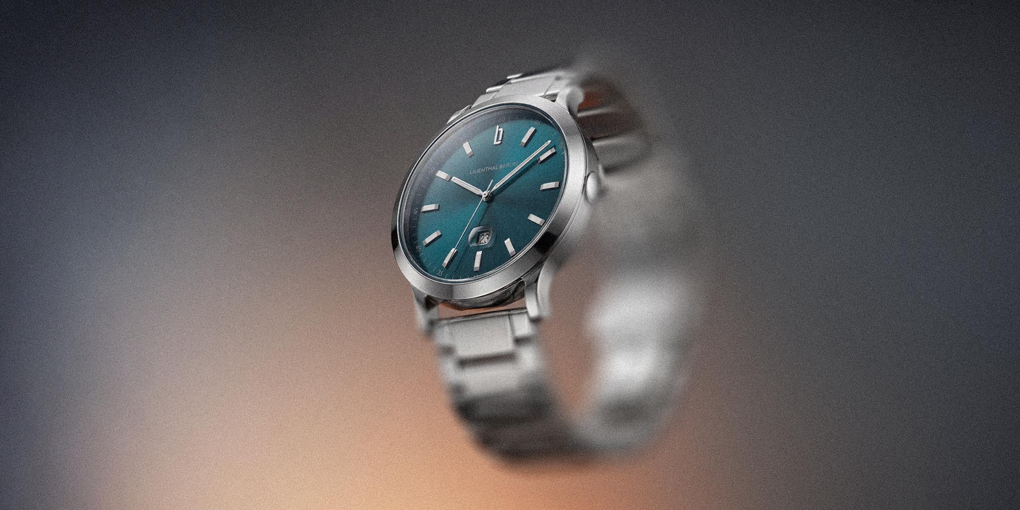 Stainless steel watch with teal blue dial and date display, minimalist modern design