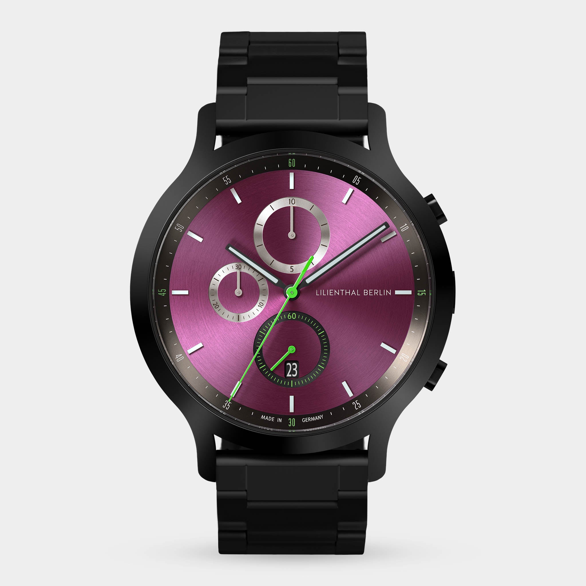 Black metal chronograph watch with a purple dial, green hands, and subdials on white background.