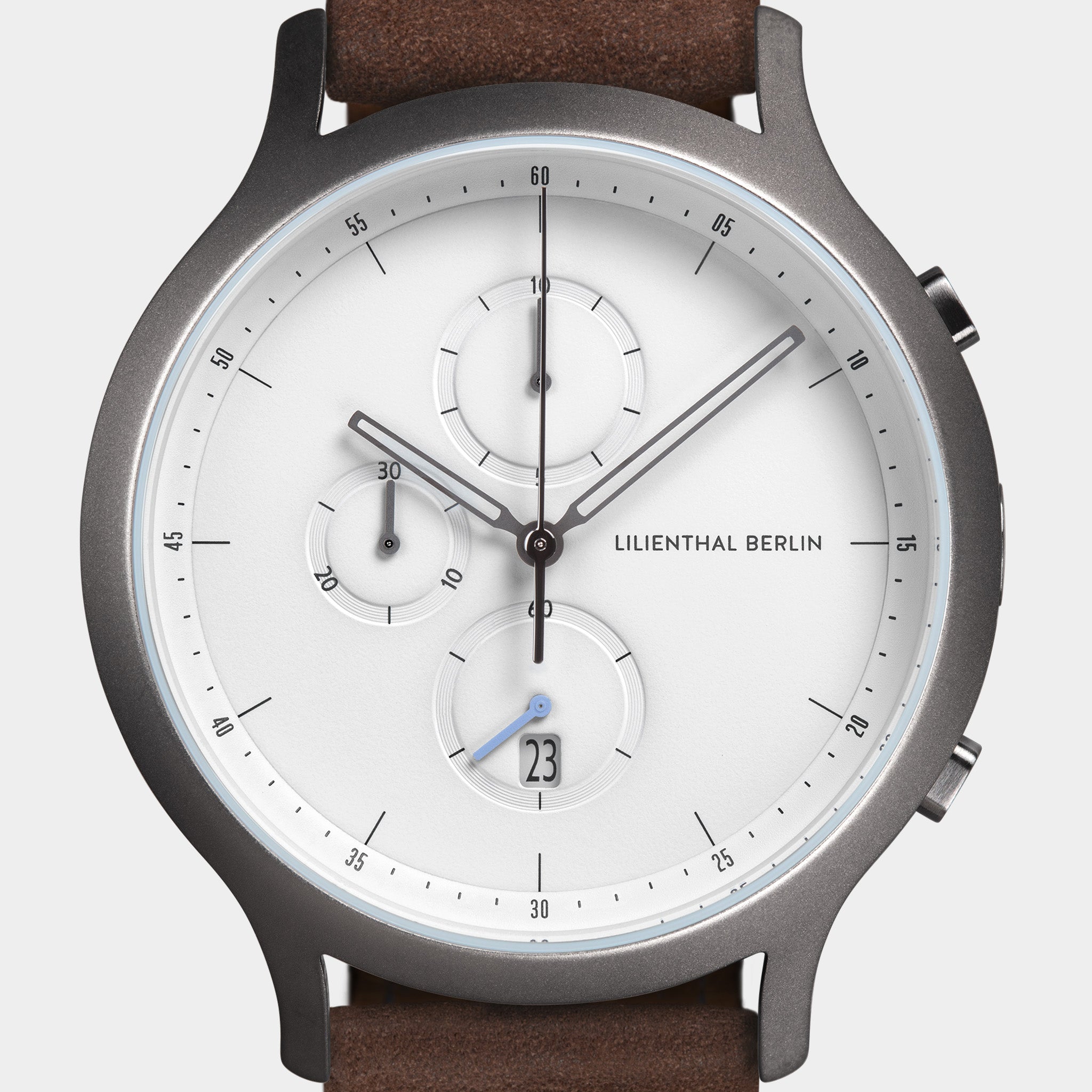 Modern chronograph watch with white dial, subdials, date display, stainless case, brown strap