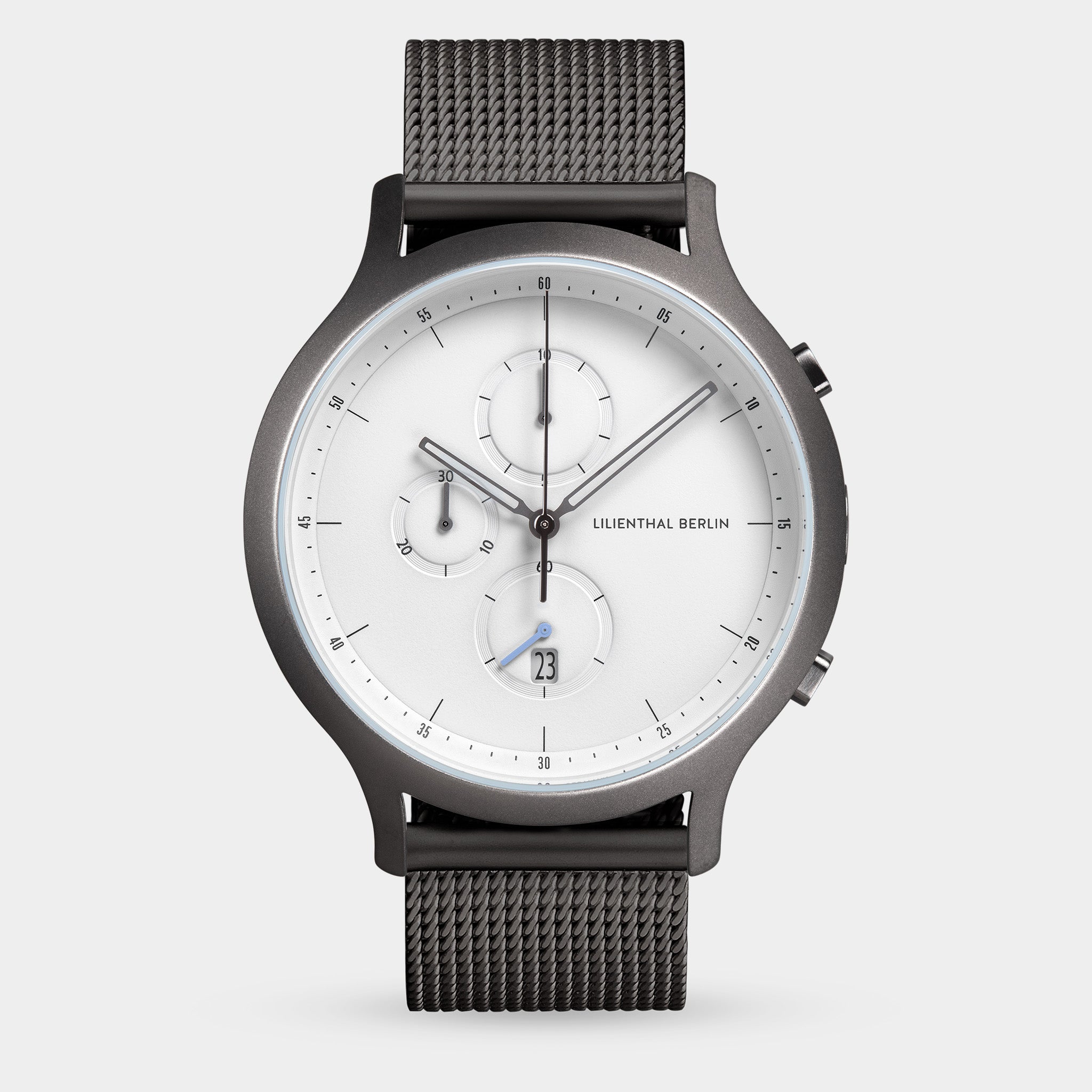 Minimalist chronograph watch with white dial, black mesh band, and date display