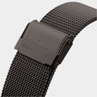 Black mesh stainless steel watch strap with clasp and engraved logo on white background
