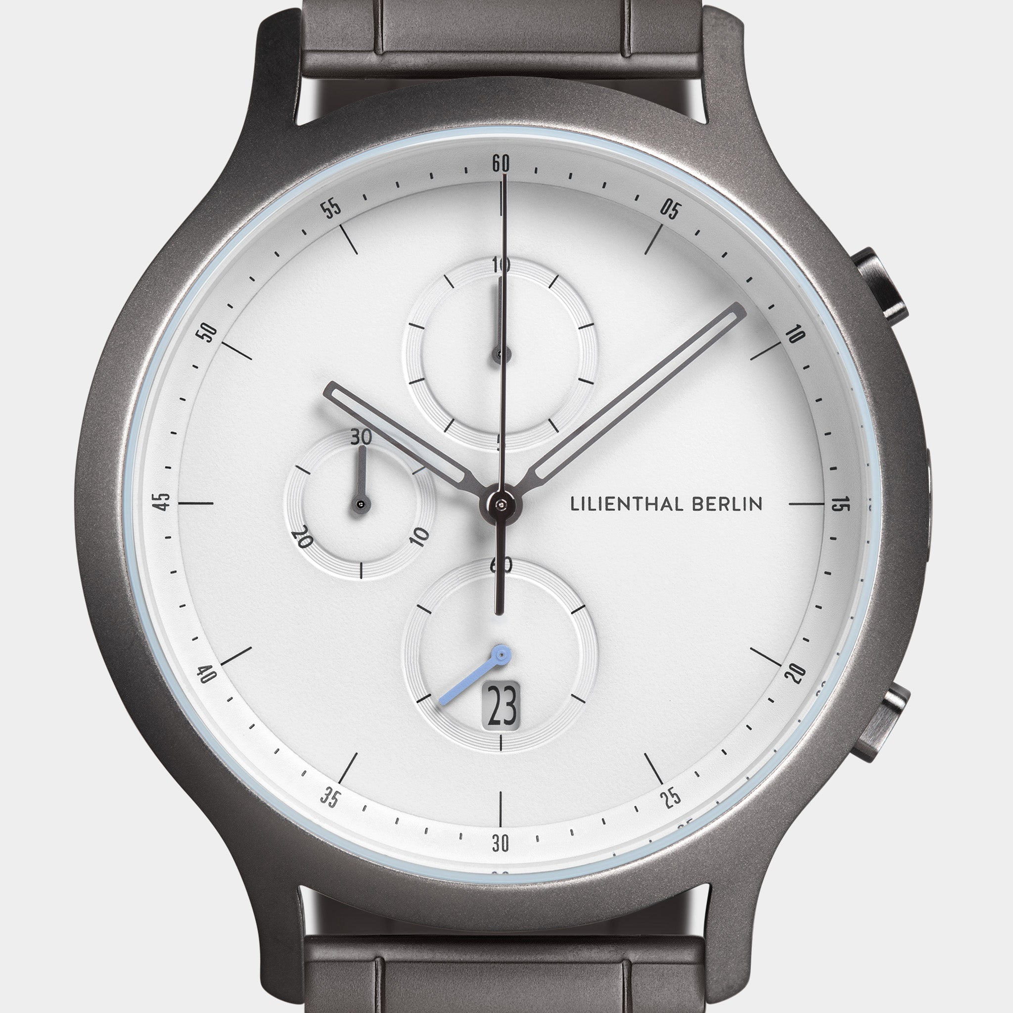 Minimalist silver chronograph watch with white dial, three subdials, and date display.