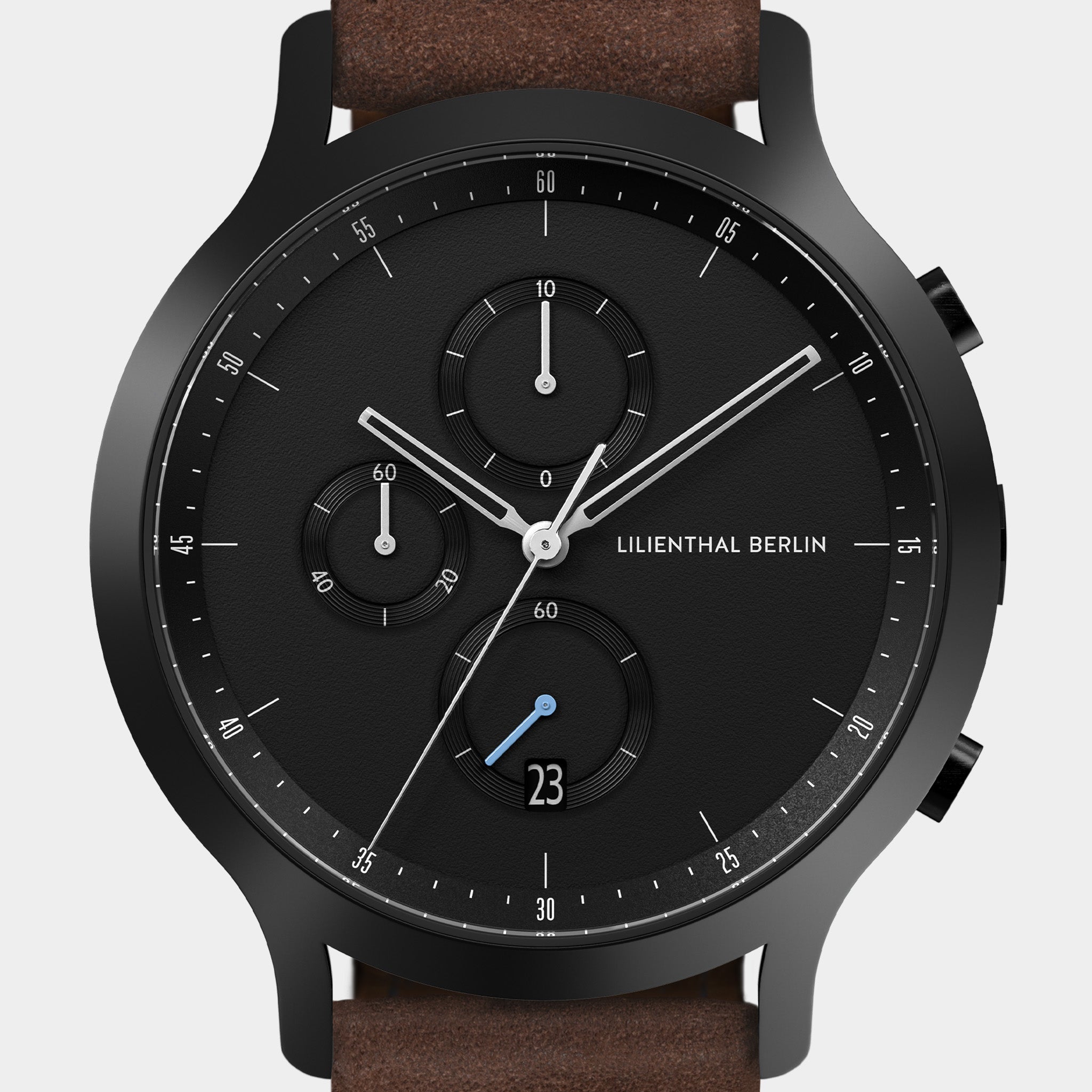 Black chronograph watch with subdials, date display, and brown leather strap