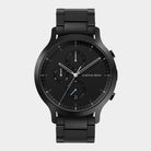 Black chronograph wristwatch with metal band, minimalist dial and three subdials on white background