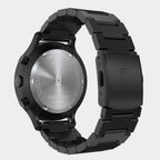 Back view of a black stainless steel chronograph watch with engraved case and metal bracelet