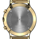 Close-up of gold chronograph watch case back with steel engraving and branded logo