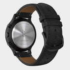 Back view of a stainless steel chronograph solar watch with black leather strap