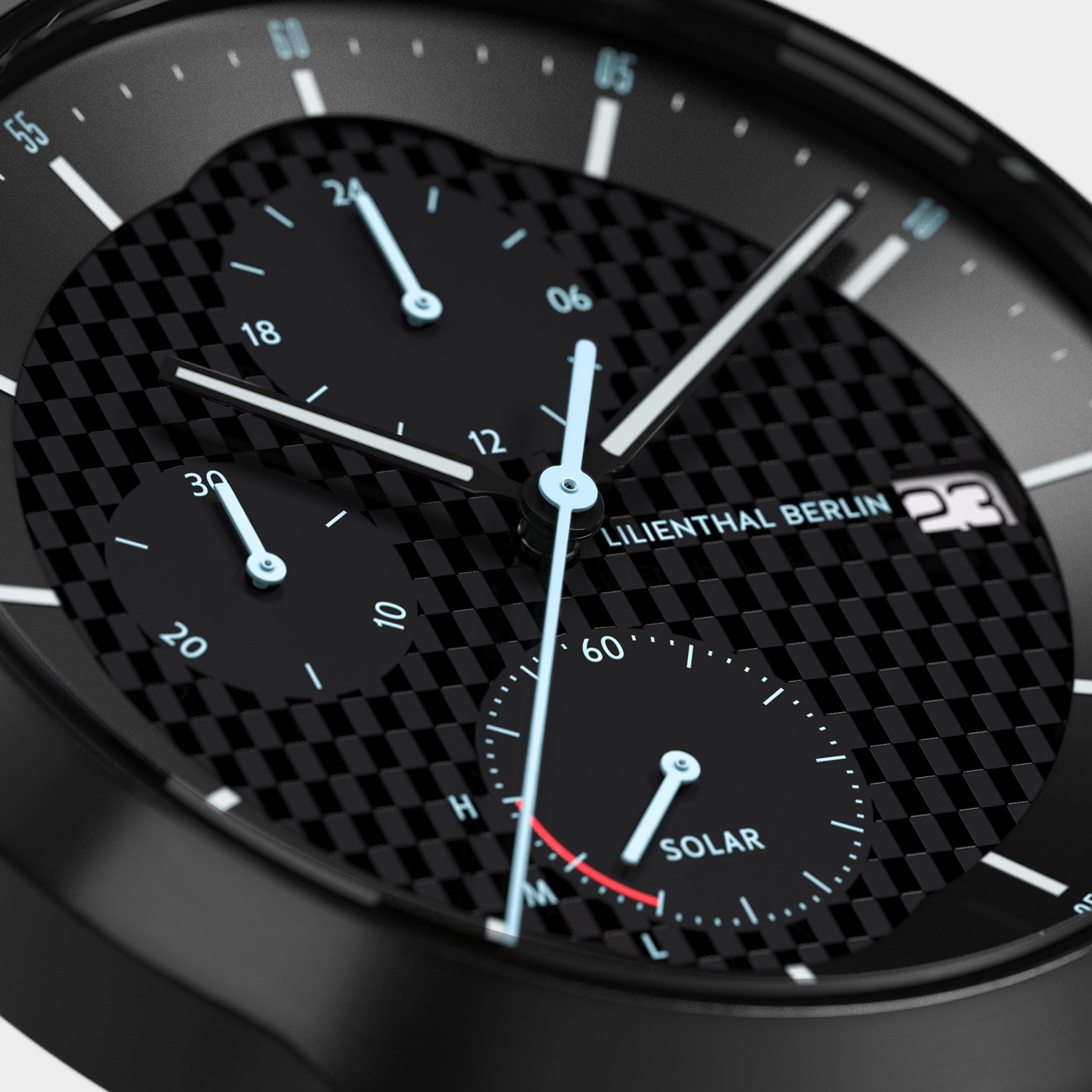 Close-up of a black chronograph watch with carbon fiber dial and luminous blue hands