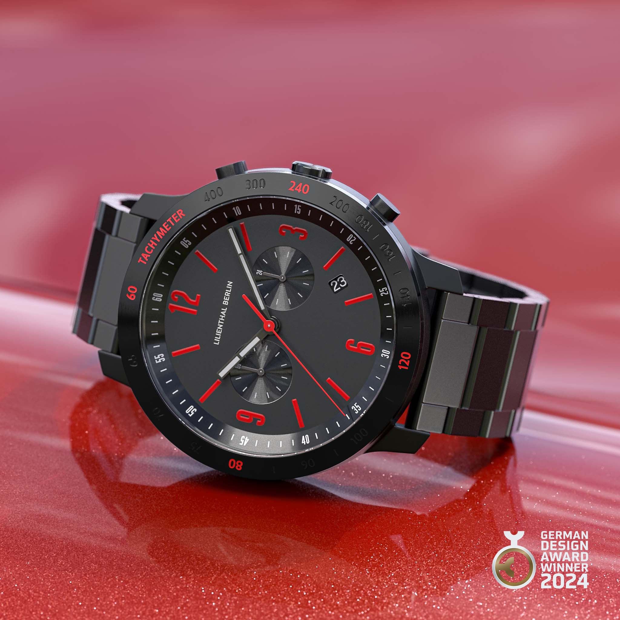 Black stainless steel chronograph watch with red accents, tachymeter bezel, and date display.