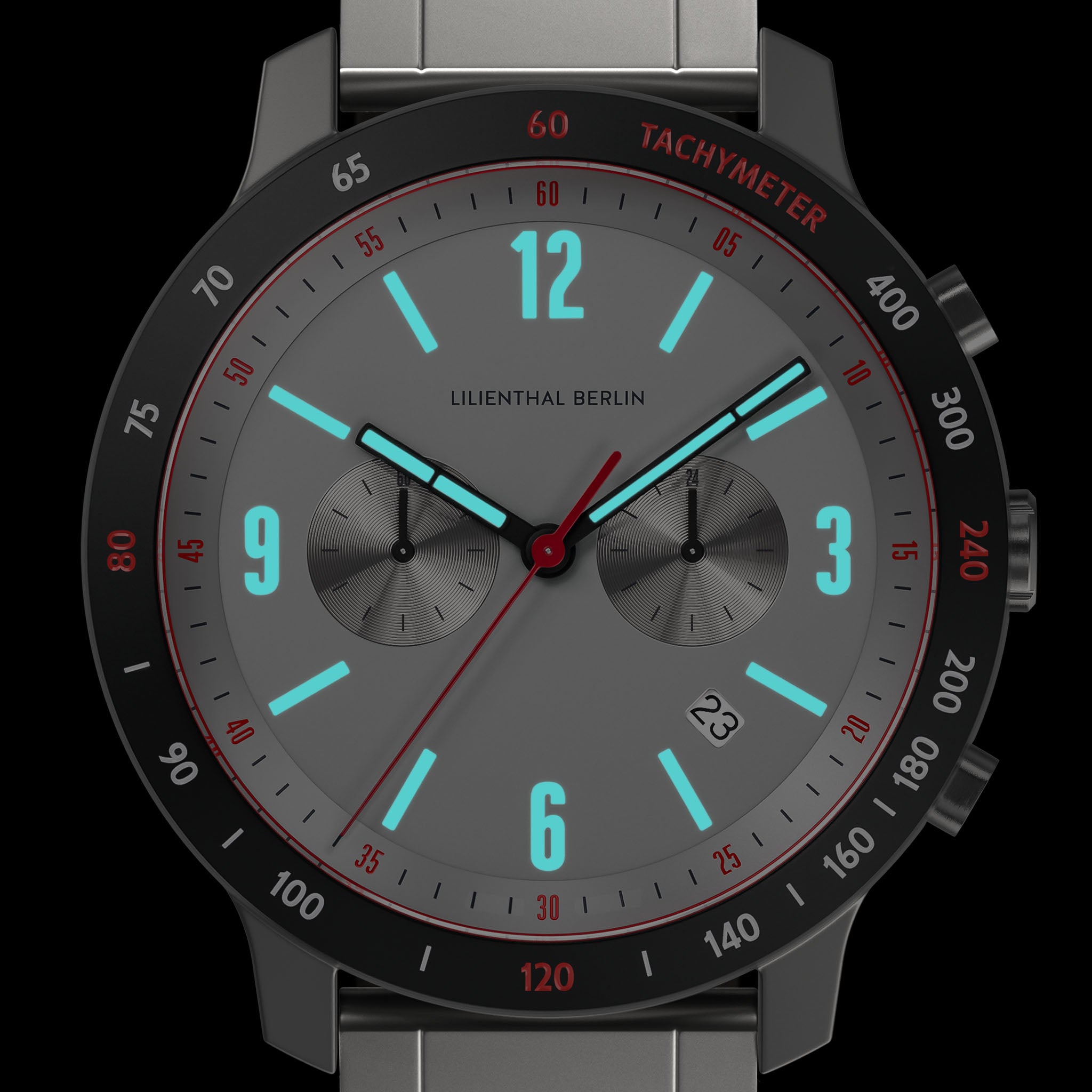 Modern chronograph watch with gray dial, luminous blue markers, and tachymeter bezel.
