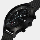 Black chronograph watch with mesh strap, textured dial, subdials, and date display