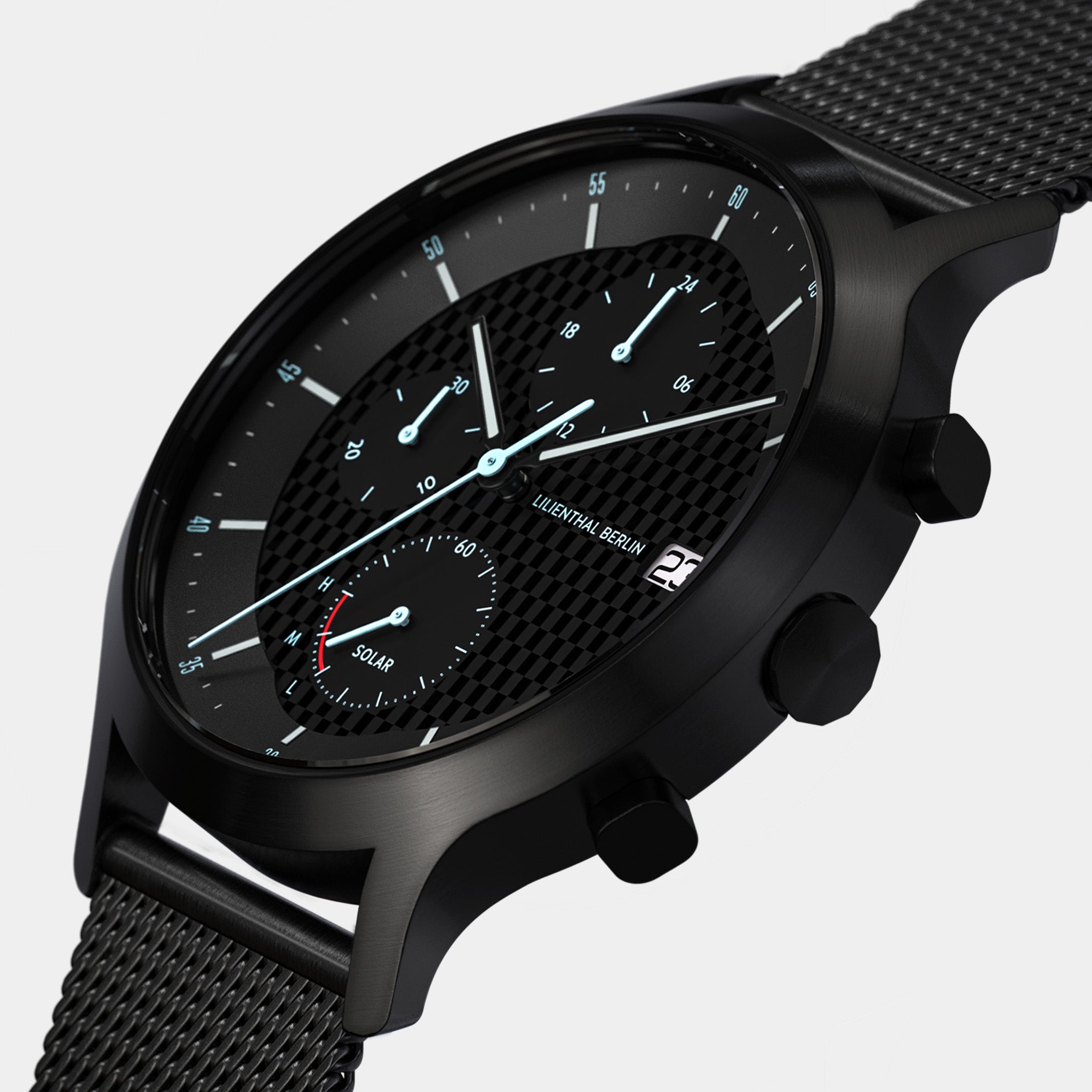 Black chronograph watch with mesh strap, textured dial, subdials, and date display