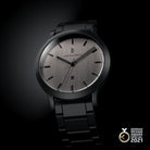 Modern black stainless steel watch with brushed silver dial and date display, German Design Award 2021.