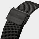 Black mesh stainless steel watch strap with engraved clasp closeup