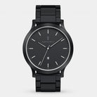 Sleek black analog wristwatch with metal band, minimalist dial, date display at 6 o'clock.