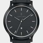 Minimalist black watch with black dial, silver hands, date display, and metal band
