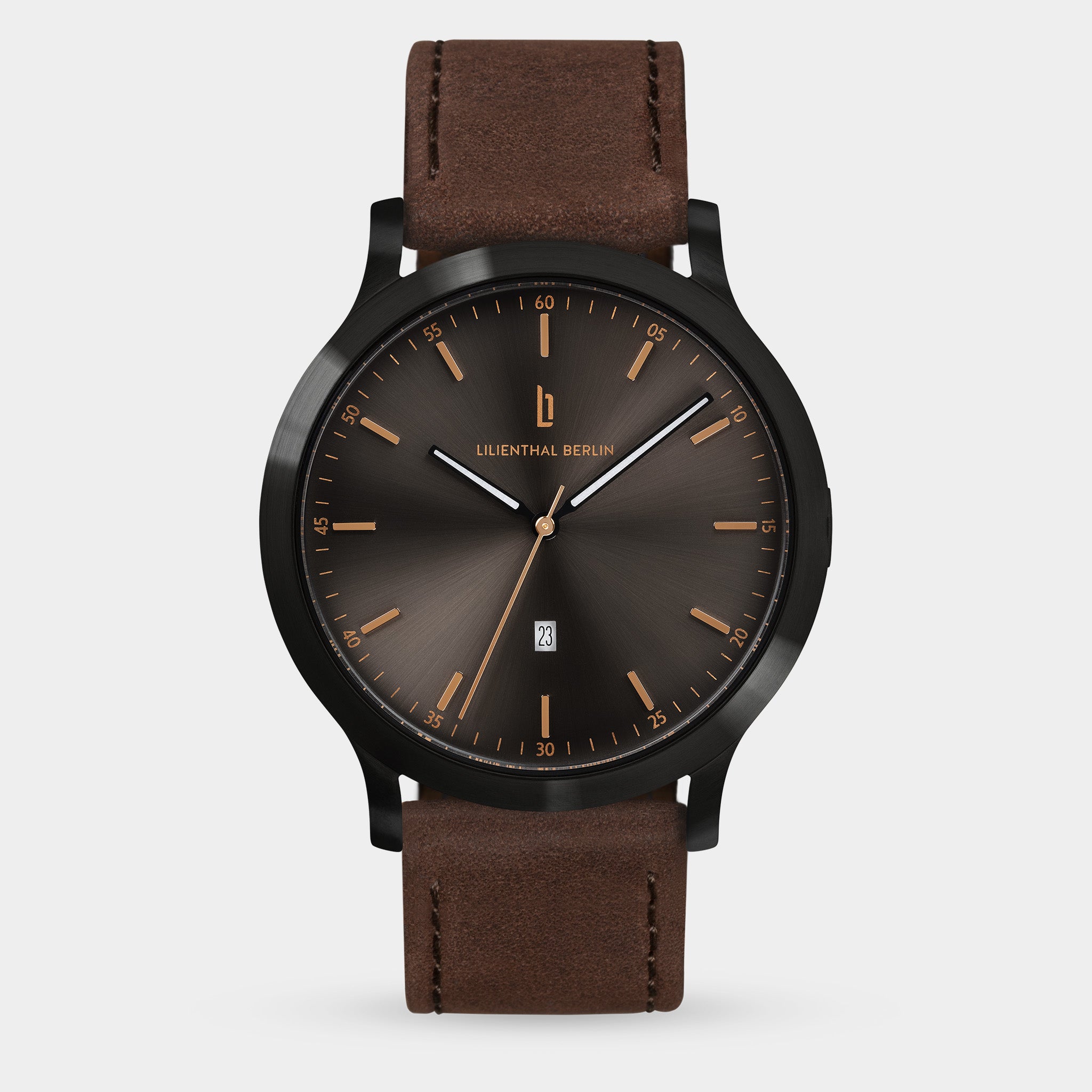 Minimalist men's watch with sunburst black dial, gold markers, and brown leather strap