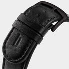 Close-up of black leather watch strap with matte black buckle