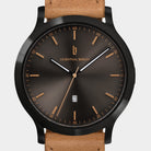 Brown sunburst dial wristwatch with date display and tan leather strap.