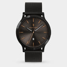 Minimalist black mesh strap watch with a dark sunburst dial and gold hour markers