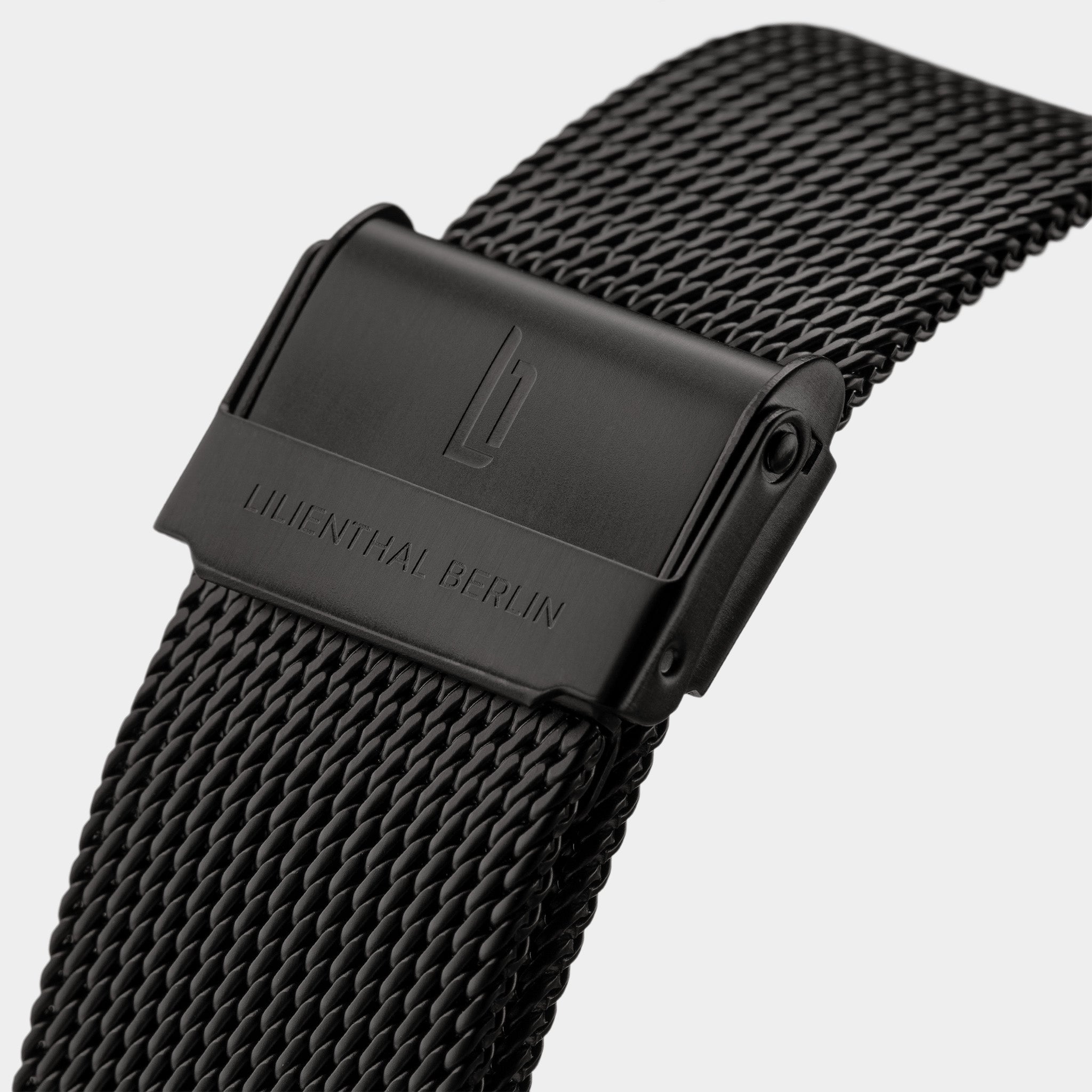 Black stainless steel mesh watch band with engraved clasp and modern design