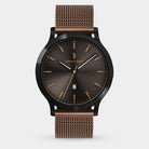 Elegant men’s watch with black sunburst dial, rose gold markers, and mesh metal strap