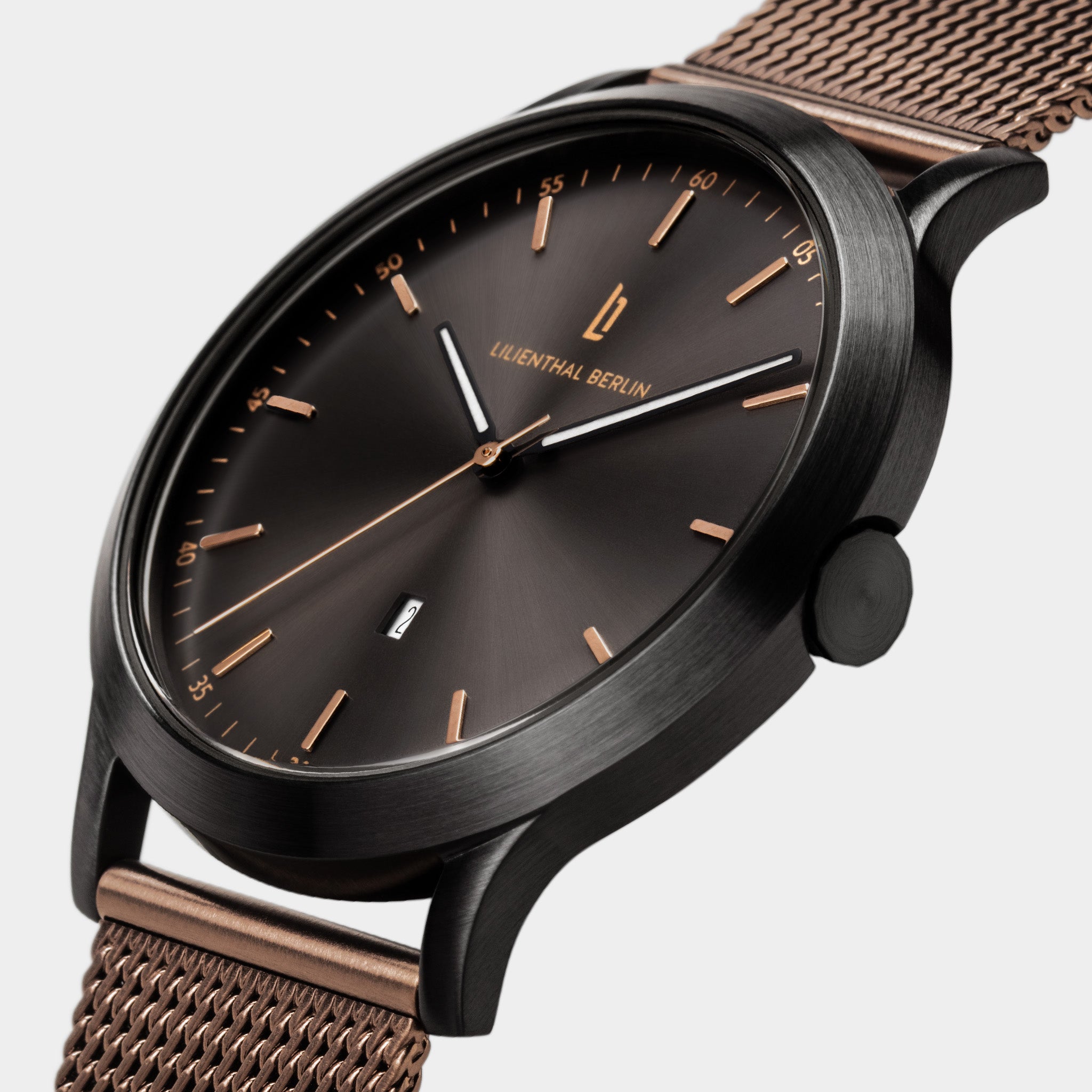 Elegant black and rose gold mesh wristwatch with minimalist dial and date display