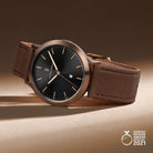 Men’s bronze wristwatch with black dial, brown leather strap, date window, German Design Award 2021