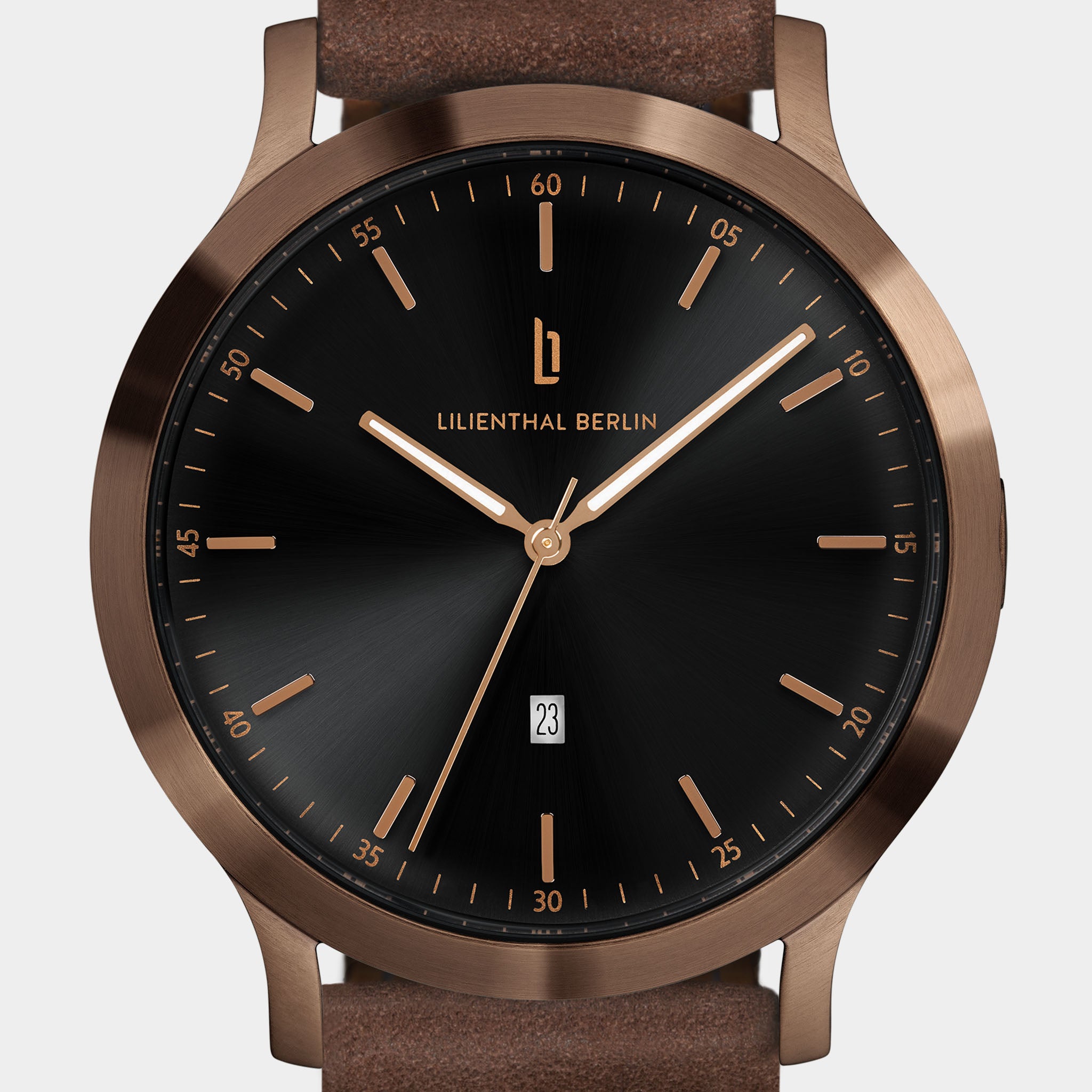 Minimalist wristwatch with black dial, bronze case, brown leather strap, and date display