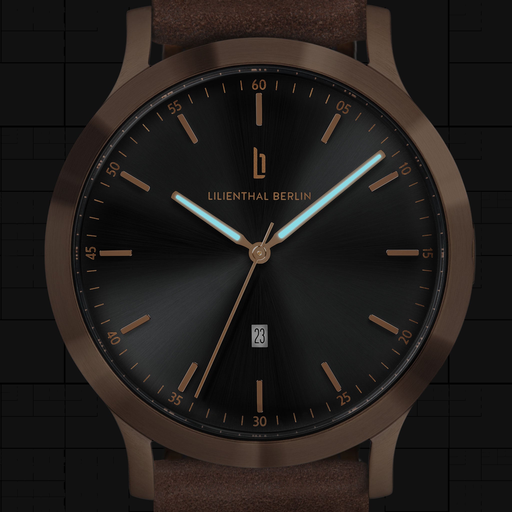 Minimalist black and bronze analog wristwatch with brown leather strap and date display