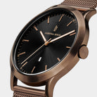 Elegant rose gold watch with black dial, date display, and mesh strap on white background