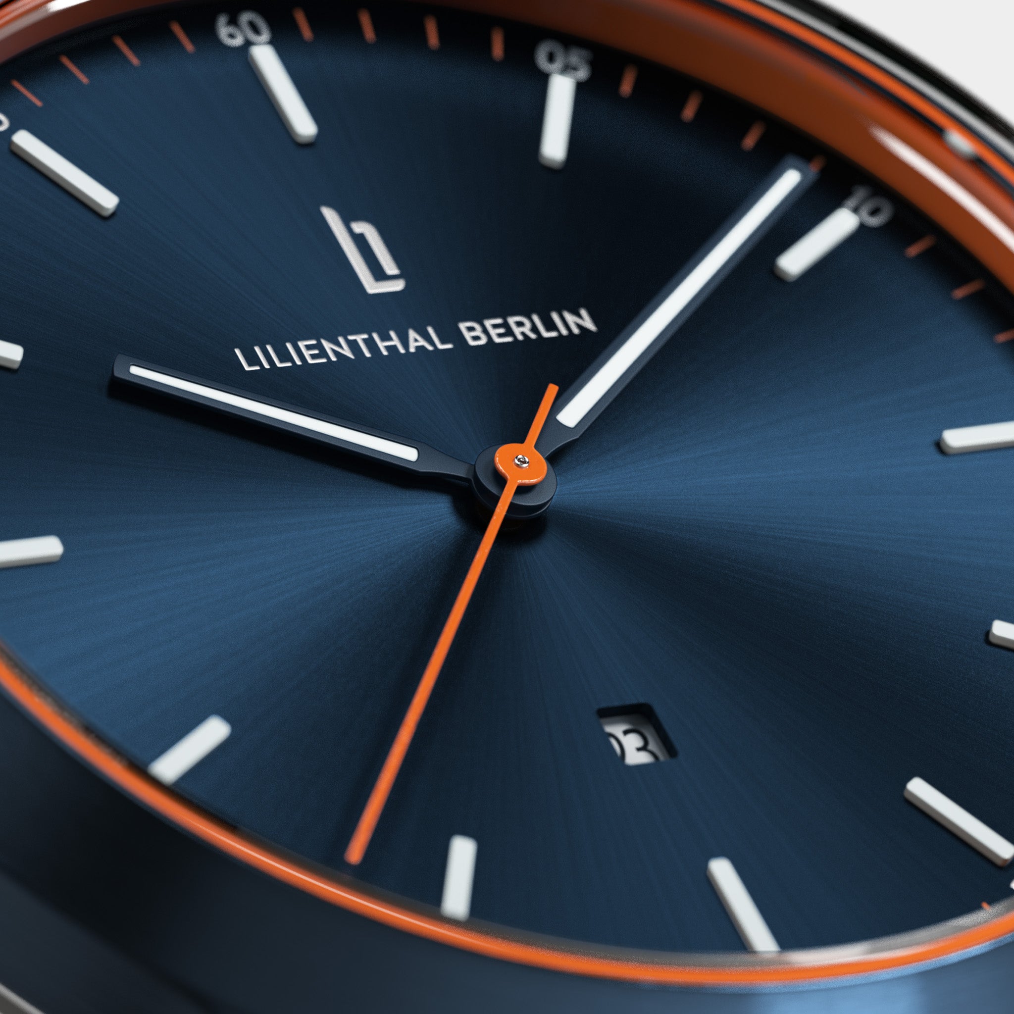 Close-up of a modern blue watch face with orange accents and date display