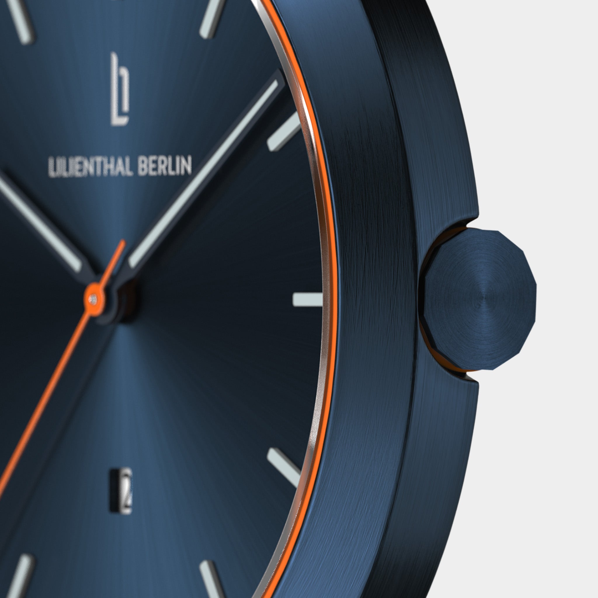Close-up of a modern blue watch face with orange accents and minimalist hour markers.