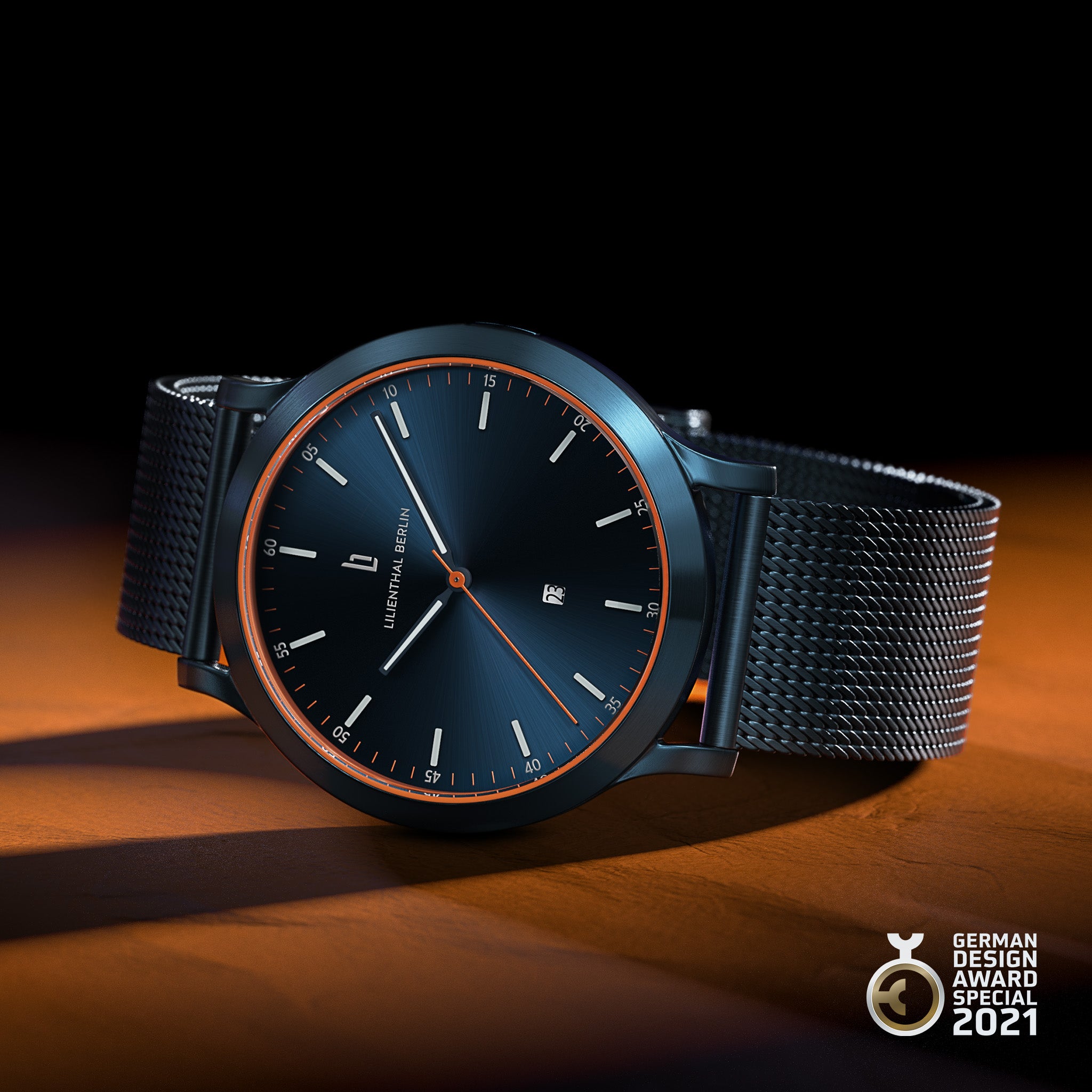 Minimalist black wristwatch with mesh strap, orange accent, and date display, German Design Award 2021 winner.