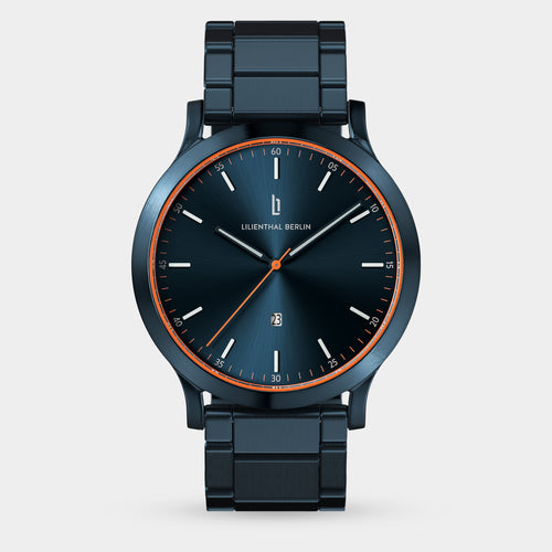 Modern blue metal wristwatch with orange accents and minimalist dial on white background